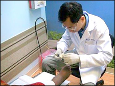 Foot Doctor providing treatment